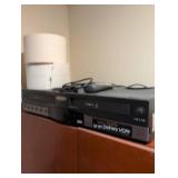 Go Video Dual VHS Player/Recorder with cabinet and contents