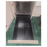 Tall Gray Metal Storage Cabinet with KU Jayhawk Stickers