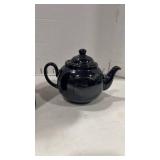 Black ceramic tea pot and black glass vase