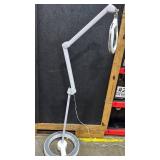 Adjustable magnifying LED lamp on wheels