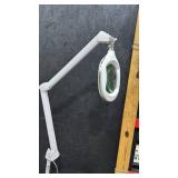 Adjustable magnifying LED lamp on wheels