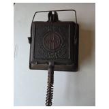 Antique Griswold Cast Iron Waffle Maker No. 11 in well-preserved condition.