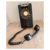 Vintage black rotary wall phone.