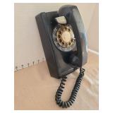 Vintage black rotary wall phone.
