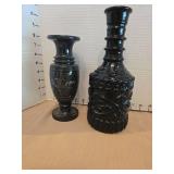 Vintage black marble vase with etched floral design and a black liquor bottle