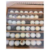 Sports teams golf ball collection in glass front hanging case