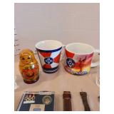 Russian nesting dolls, ICT mugs, shot glasses, pins, watches