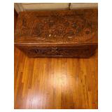 Early 20th Century beautiful hand-carved Asian camphor wood trunk with brass latch, 19x35x17. Latch needs minor repair.