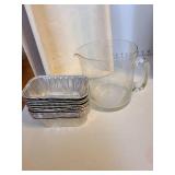 Tupperware deviled egg carrier, porcelain tea mug with lid and infuser on red plastic tray, lined basket, glass pitcher, more