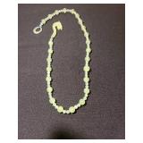 Chinese carved celadon Jade bead necklace with a dragon clasp.