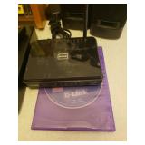 Toshiba DVD Player SD-4100, D-Link, Pair of JBL Speakers, Jawbone Jambox, Remotes, Various Connection and Power Cords, and Collection of Popular Movie DVDs with Rack