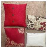 Assorted decorative throw pillows -- red, cream, & brown tones