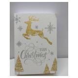 Elegant holiday featuring a leaping gold foil reindeer with silver snowflakes and calligraphic 