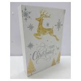 Elegant holiday featuring a leaping gold foil reindeer with silver snowflakes and calligraphic 