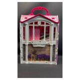 Barbie Glam Getaway House playset. This portable dollhouse unfolds to reveal a play space featuring three rooms: a kitchenette, bedroom, and en suite bathroom. With lots of accessories