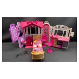 Barbie Glam Getaway House playset. This portable dollhouse unfolds to reveal a play space featuring three rooms: a kitchenette, bedroom, and en suite bathroom. With lots of accessories