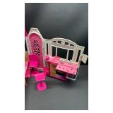 Barbie Glam Getaway House playset. This portable dollhouse unfolds to reveal a play space featuring three rooms: a kitchenette, bedroom, and en suite bathroom. With lots of accessories