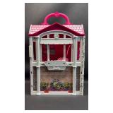 Barbie Glam Getaway House playset. This portable dollhouse unfolds to reveal a play space featuring three rooms: a kitchenette, bedroom, and en suite bathroom. With lots of accessories