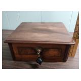 Antique Wood Box with ornate brass escutcheon and black wood drop pull handle.  Could be considered a small lap writing desk. 10.5" W x 11.25"D x  4.25" H