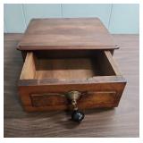 Antique Wood Box with ornate brass escutcheon and black wood drop pull handle.  Could be considered a small lap writing desk. 10.5" W x 11.25"D x  4.25" H