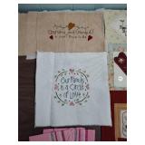 Handcrafted Family Quilt Blocks, Embroidered projects, and a set of pink plaid napkins