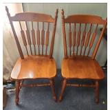 Two vintage solid Maple dining chairs with Spindle backs and turned legs. 18"W x 16.5" D x 38"H. Seat height 17".  Very good condition. Slight finish wear on top spindles of one chair