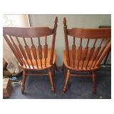 Two vintage solid Maple dining chairs with Spindle backs and turned legs. 18"W x 16.5" D x 38"H. Seat height 17".  Very good condition. Slight finish wear on top spindles of one chair