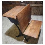 Antique American School Desk with Cast Iron Base and folding front chair. 22"W x 28"D x 30"H. Seat height 15". Desk height 26". Has finish wear and markings on the wood.