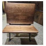 Antique American School Desk with Cast Iron Base and folding front chair. 22"W x 28"D x 30"H. Seat height 15". Desk height 26". Has finish wear and markings on the wood.
