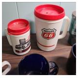 Phillips 66 Promotional Items - coffee mugs, travel mugs, ink pens, shot glass, and a zipper pouch.