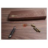 Outers Gun Cleaning Kit , a few vintage bullets, picket knife, and an acrylic keychain with an airplane inside