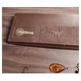 Outers Gun Cleaning Kit , a few vintage bullets, picket knife, and an acrylic keychain with an airplane inside