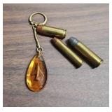 Outers Gun Cleaning Kit , a few vintage bullets, picket knife, and an acrylic keychain with an airplane inside