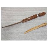 Wood carved knives - one is of an Egyptian the other says Walker State Park