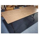 6 foot wood laminate top folding table - measures 72" L x 29.75" W x 29.25" H - has surface scratches and wear but very sturdy