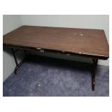 5 foot wood laminate top folding table - measures 60" W x 30" W x 29" H - has some paint splatters on it, but otherwise edges are in good condition and it is sturdy