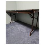 5 foot wood laminate top folding table - measures 60" W x 30" W x 29" H - has some paint splatters on it, but otherwise edges are in good condition and it is sturdy