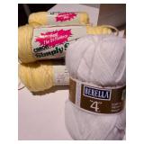 Large Christmas tin full of yellow and white yarn