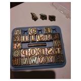 Metal alphabet stamps in storage tray