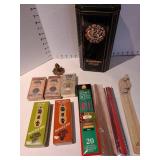 Incense burners with incense, plus a Christian Brothers brandy tin.