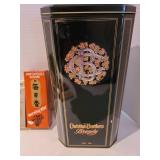 Incense burners with incense, plus a Christian Brothers brandy tin.