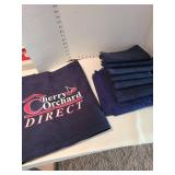 Navy blue fabric and a Cherry Orchard banner in a lined basket
