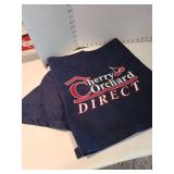 Navy blue fabric and a Cherry Orchard banner in a lined basket