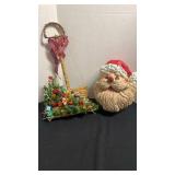 Decorative snow shovel full of presents and hanging Santa