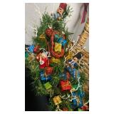 Decorative snow shovel full of presents and hanging Santa