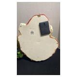 Decorative snow shovel full of presents and hanging Santa