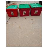 Three red and green holiday storage totes.
