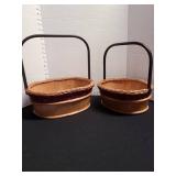 2 wood baskets with metal handles.