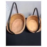 2 wood baskets with metal handles.