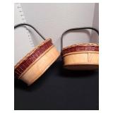 2 wood baskets with metal handles.